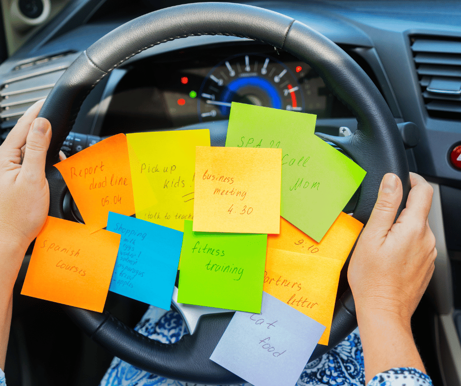 an overwhelmed ADHD and busy mom with several sticky notes with things to do on her steering wheel while she is driving