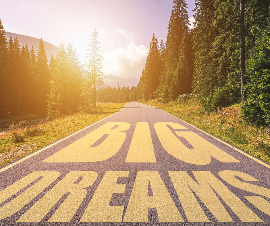 a picture of mountains and trees and the words big dreams written on the road.