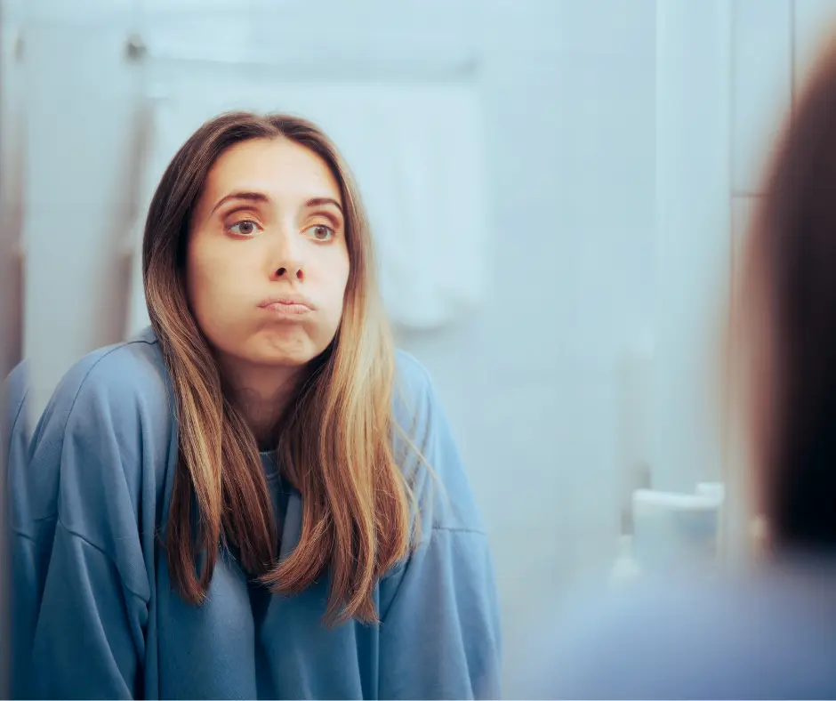 overwhelmed mom hiding from her kids in the bathroom